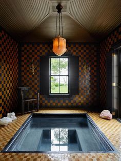 an indoor swimming pool with tiled flooring and walls in the shape of checkered tiles