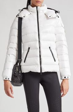 Whether you're headed somewhere metropolitan or mountainous, you'll stay warm in this sporty down puffer made from Moncler's water-resistant lacquered nylon. Elasticized cuffs and a detachable drawcord hood provide extra protection from the elements. Two-way front-zip closure Stand collar; removable drawcord hood Elastic cuffs with adjustable snap tab Front zip pockets; sleeve snap-flap pocket Lined, with down fill 100% polyamide Dry clean or machine wash, line dry Imported Designer Clothing Luxury Puffer Jacket For Outdoor Fall Use, Luxury Puffer Jacket For Fall Outdoor, Luxury Down Puffer Jacket For Outdoor, White Sporty Puffer Jacket With Padded Collar, Luxury Nylon Puffer Jacket For Outdoor, Luxury Puffer Jacket With Padded Collar For Outdoor, White Puffer Jacket With Zipper For Outdoor, Luxury Nylon Puffer Jacket, Luxury Outdoor Puffer Jacket With Padded Collar