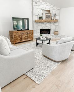 a living room filled with furniture and a flat screen tv on top of a wooden stand