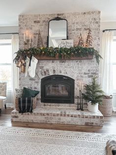 a living room filled with furniture and a fire place covered in christmas decorations on top of a mantle