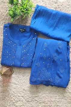 Nibs Tog Blue Chikankari Kurta Palazzo Set with Dupatta This Blue ensemble is a perfect to have for any wedding function or festivals and if it is Chikankari hand embroidered, then its a perfect outfit to pick without a doubt. Get is customized in your color choice. Check full details below: Outfit Features; Fabric:  Kurta & Palazzo both are made of Pure viscose georgette fabric. A soft Chiffon dupatta add the elegance to the outfit. Style & Pattern:  The Kurta is made in straight style with bea Blue Traditional Wear Straight Kurta With Dupatta, Blue Traditional Wear With Dupatta Straight Kurta, Blue Anarkali Set With Zari Work Straight Kurta, Blue Anarkali Set With Zari Work, Festive Blue Unstitched Sharara, Blue Art Silk Kurta With Dupatta, Blue Unstitched Sharara For Festive Occasions, Blue Dola Silk Anarkali Set With Straight Kurta, Blue Semi-stitched Sharara