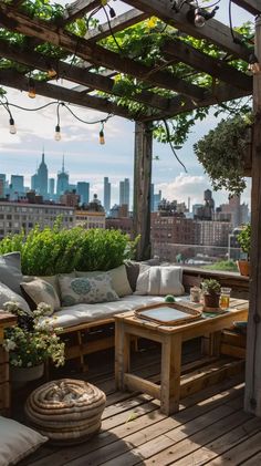 an outdoor living area with couches, tables and potted plants on the roof