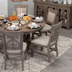 a dining room table set with plates and bowls