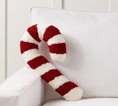 a red and white striped candy cane on a white couch