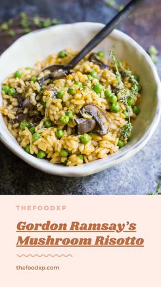 a bowl filled with mushroom risota on top of a stone counter next to a spoon