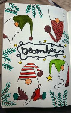 an open notebook with christmas doodles on the cover and writing below it that says, december