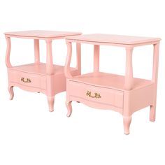 two pink end tables with drawers on each side