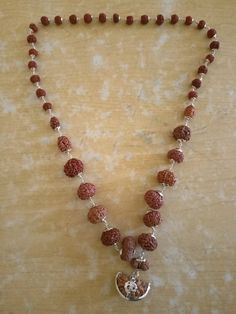 Name: Rudraksha Siddha Mala Configuration: 1 to 14 mukhi + 1 Pcs Gaurishanker + 1 Pcs Ganesha Rudraksha. (Total: 16 Pcs) Origin: All Indonesian except 1 Mukhi Indian Quality: 100% Authentic - Superfine Note: Due to Natural Seed color varies from light brown to dark brown. Rudraksha Siddha Mala is a very powerful healing combination. Worn for Dharma, Artha, Kama, Moksha. The synergistic combination of all mukhis worn on the body provides the wearer with abundance in wealth, renewed energy, good h Traditional Jewelry For Meditation With 8mm Beads, Traditional Jewelry With 8mm Beads For Meditation, Traditional 8mm Beads Jewelry For Meditation, Gemstone Beads Mala For Puja And Festivals, Polished Beads Mala For Puja In Temple Jewelry Style, Temple Jewelry Mala For Navratri Meditation, Festival Mala With Gemstone Beads For Puja, Spiritual Festive Mala With Latkans, Temple Jewelry Mala With Polished Beads For Puja