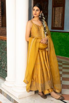 Mustard anarkali with floral motif zari embroidery. Comes with silk pant and dupatta.
Component: 3
Pattern: Embroidered
Type Of Work: Floral Motifs
Neckline: V-Neck
Sleeve Type: Sleeveless
Fabric: Anarkali and Pant: Silk, Dupatta: Organza
Color: Yellow
Other Details: 
Floral motif embroidery
Sheer dupatta
Occasion: Mehendi and Haldi - Aza Fashions Pakistani Maxi, Pakistani Maxi Dresses, Sleeveless Anarkali, Maxi Frocks, Floral Anarkali, Yellow Anarkali, Eid Dress, Silk Anarkali, Embroidered Anarkali