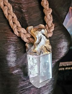 This luxury boho couture statement pendant - talisman - amulet features a 5.5' x 2.25' faceted quartz crystal, sculpted in a unique design and suspended from a braided jute rope. It is a unisex piece of jewelry, perfect for both men and women. This edgy street style jewelry is perfect for any occasion. It is a timeless piece that will add a touch of elegance to any outfit. The quartz crystal is believed to bring positive energy and healing properties. This unique piece of jewelry is available ex Unique Quartz Crystal Necklaces With Natural Stones, Bohemian Crystal Necklace With Large Adjustable Stone, Bohemian Crystal Necklace With Large Stone, Bohemian Hand Cast Healing Jewelry, Bohemian Healing Jewelry Hand Cast, Handmade Spiritual Quartz Crystals, Bohemian Jewelry With Large Mineral Crystal Stone, Bohemian Pendant Crystal Necklaces With Large Stone, Bohemian Crystal Pendant Necklace With Large Stone