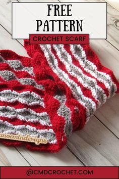 two crocheted red and gray striped dishcloths sitting on top of each other