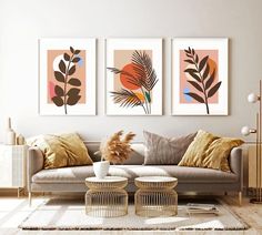 a living room filled with furniture and paintings on the wall above it's coffee table