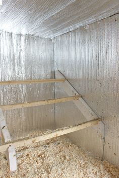 the inside of a chicken coop with metal walls