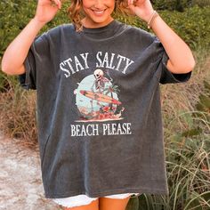 Stay Salty Grunge Style Comfort Colors Beach T-Shirts, Stay Salty Beach Please Tee Shirt, Stay Salty Beach Gift, Summer Beach Grunge Shirt.  Orders are processed within 24 hours and shipped out within 2 to 5 business days. What you receive: Comfort Colors Adult Unisex Crewneck T-shirt Color Choices: Yam Chambray  Blue Jean Pepper  Ivory Sizes: Unisex adult sizing use size chart as a guide. These shirts are fitted and run true to size. If you prefer a loose fit go one size larger. If you want an Black Text Print Top For Vacation, Black Text Print Tops For Vacation, Black Tops With Funny Print For Vacation, Funny Print Black Tops For Vacation, Black Top With Funny Print For Vacation, Black Tops With Funny Print For The Beach, Funny Print Black Top For The Beach, Vacation Graphic Tee Shirt With Letter Print, Black Beach Tops With Funny Print