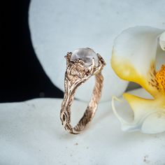 "Our iconic Moonstone ring \"Daisy\" got a new frame - this beauty is hand crafted in Solid 14K Rose Gold, what makes it an ideal heirloom. Created from durable materials, it has a nature-inspired design that is always relevant. Genuine Moonstone will be selected from the best specimens of our collection - you can be sure that nobody will remain indifferent to its divine shimmer. Exquisite craftsmanship is manifested in finely carved details - small leaves and flowers bloom on an artfully recrea Nature-inspired Moonstone Wedding Ring, Handmade Rose Gold Moonstone Wedding Ring, Handmade Rose Gold Moonstone Ring For Wedding, Handmade Nature-inspired Moonstone Ring For Wedding, Ethereal Rose Gold Jewelry For Anniversary, Handmade Fine Jewelry Moonstone Wedding Ring, Handmade Fine Jewelry Moonstone Ring For Wedding, Handmade Moonstone Ring For Wedding, Nature-inspired Rose Gold Gemstone Rings