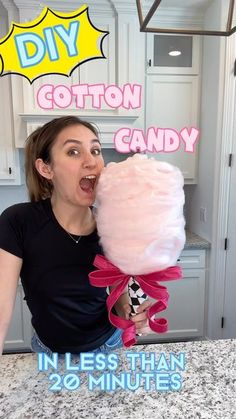 a woman holding a giant cotton candy in her mouth with the words, diy cotton candy in less than 20 minutes