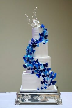 a wedding cake with blue butterflies on it