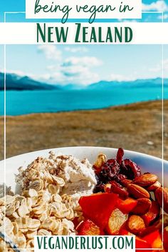 a white bowl filled with food on top of a wooden table next to the ocean