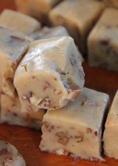 several pieces of fudge sitting on top of a wooden cutting board