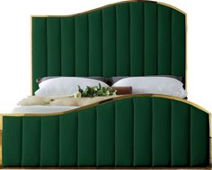 a bed with green headboard and white pillows