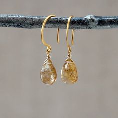 Sparkly and gorgeous, teardrops of Golden Rutilated Quartz hang simply from 24k gold vermeil ear wires. These are lightweight earrings that will wear easily. Golden Rutilated Quartz, also known as Angel's Hair Quartz, is a clear quartz with fine, gold needles or strands of inclusion visible inside. These needles or "rutiles" are minerals containing titanium oxide. It's a truly eye-catching stone that is thought to help the wearer increase mental clarity and aid in decision making.{ The earrings Teardrop Earrings With Natural Inclusions, Wire Wrapped Teardrop Earrings For Anniversary, Yellow Gold Gemstone Teardrop Earrings, Yellow Gold Teardrop Dangle Earrings With Gemstone, Gold Teardrop Gemstone Earrings, Rutilated Quartz Jewelry, Textured Gold Ring, Golden Rutilated Quartz, Lightweight Earrings