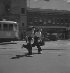 black and white photograph of two women walking down the street