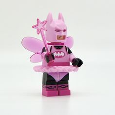 a pink batgirl minifigure holding a star