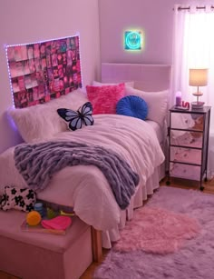 a bedroom decorated in pink, purple and white