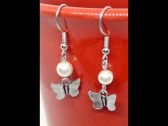 Adorable butterfly charm earrings nestled beneath a beautiful white pearl on a silver plated wire hook. They are just over 1/2 inches long. These little cuties look like they have just taken off in flight! Perfect gift for a butterfly lover! Can be worn with most everything! Arrives in a beautiful silver gift box ready for gifting!! Come visit our shop to see more hand stamped metals, charms and high quality gemstones https://FrostUS.etsy.com To care for your special piece do not wear to bed, in Silver Butterfly Earrings, Hand Stamped Metal, Pearl Butterfly, Earrings Butterfly, Silver Gift Box, Butterfly Jewelry, Earrings Pearl, Wire Wrapped Rings, Silver Butterfly