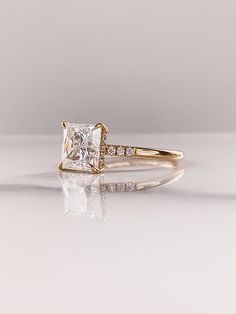 an engagement ring with a princess cut diamond