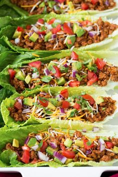 lettuce wraps filled with ground beef, tomatoes and cheese on a white platter