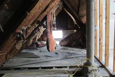 an attic with wooden floors and exposed walls