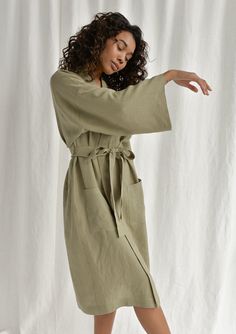 Spoil yourself with a linen bathrobe that's incredibly soft, light, and breathable. Handcrafted of premium quality European linen, this moss green kimono-style bathrobe feels so good to the skin, you'll never want to take it off. The linen robe features a relaxed fit, long sleeves, an adjustable waistband, and comfy outer pockets, making it the ultimate addition to your at-home wear. The model is 175 cm (69'') tall and is wearing a bathrobe in size S/M. DETAILS - Handmade from high-quality Europ Linen Kimono With Kimono Sleeves For Loungewear, Linen Kimono For Daywear, Relaxed Fit Linen Robe For Spring, Green Kimono Sleeve Robe For Loungewear, Green Robe With Kimono Sleeves For Loungewear, Green Spring Robe For Loungewear, Summer Linen Robe With Kimono Sleeves, Summer Linen Kimono For Loungewear, Relaxed Fit Linen Kimono For Daywear