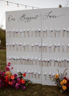 two large white signs with flowers on them and one sign that says our biggest four