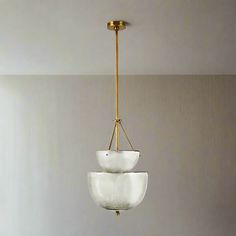 a chandelier hanging from the ceiling in a room with white walls and flooring