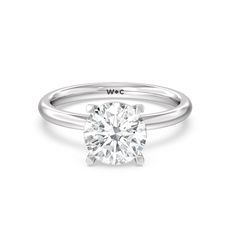 a white gold engagement ring with a round diamond