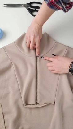 a woman is cutting fabric with scissors