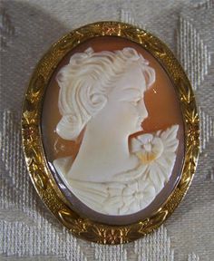 I am offering you this truly exquisite vintage cameo pin brooch , all done in 12 K yellow gold filled, with rose gold accents. This cameo has a very Victorian style female woman depicted on this cameo. What a fantastic opportunity to purchase a most uniquely shaped fancy large cameo , with an amazing very raised convex female cameo What a spectacular design.... So very elegant yet simple at the same time. The cameo is large and has fantastic meticulous carving, with extreme depth and detail to i Ornate Cameo Brooch For Anniversary, Vintage Gold Intaglio Brooches, Ornate Cameo Brooches For Anniversary, Victorian Cameo Brooch For Anniversary, Heirloom Cameo Brooches For Collectors, Antique Oval Cameo Brooch, Cameo Round Brooch Collectible, Collectible Oval Cameo Brooch, Classic Cameo Collectible Brooches