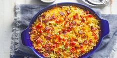 a casserole dish with sausage, peppers and cheese in it on a table