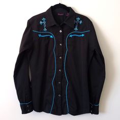 Black Wrangler Cowboy Shirt. Pearl Snaps. Size Medium. I Bought And Never Got To Wear It. Nwot Cowboy Cross In Cheetah Print Outlined In Blue Piping On Back And Both Front Yokes. Blue Piping Accents On Sleeves, Front And Back. All Snaps Work, No Rips, Stains Or Tears. This Is A Very Eye Catching Shirt. Measurements Neckline To Hem: 28" Sleeve: 25" Pit To Pit: 21" Black Long Sleeve Western Shirt, Black Western Button-up Shirt, Western Black Button-up Shirt, Western Style Black Button-up Shirt, Western Black Cotton Shirt, Black Western Style Cotton Shirt, Black Cotton Western Shirt, Western Style Black Long Sleeve Tops, Black Long Sleeve Top For Rodeo