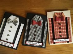 three different types of men's shirts and ties are displayed in boxes on a table