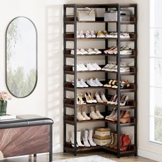 a shoe rack with many pairs of shoes on it and a mirror in the corner