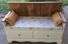 a bench made out of an old dresser with two pillows on the top and bottom