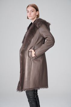 Women's Shearling Leather Trench Coat In Dark Brown Elevate your winter wardrobe with our women's shearling leather trench coat in Dark Brown. Crafted from genuine sheepskin leather with a semi-aniline finish, shop trench leather coat features a cozy faux shearling inner shell. The hooded fur collar adds a touch of sophistication and warmth, while the zipper closure ensures a snug fit. Designed with open hem cuffs, one inside pocket, and two side zip pockets, this dark brown trench coat offers both style and functionality, making it a perfect choice for cold weather. Outer Shell: Genuine Leather Leather Type: Sheepskin Leather Finish: Semi-aniline Inner Shell: Faux Shearling Feature: Hooded Fur Collar Closure Style: Zipper Collar Style: Hooded Cuffs Style: Open Hem Inside Pockets: One Outs Leather Shorts Women, Short Leather Skirts, Leather Jumpsuit, Shearling Vest, Studded Jacket, Distressed Jacket, Sheepskin Jacket, Leather Trench, Suede Coat