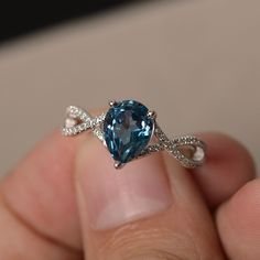 This is a gorgeous handmade creation. Its beauty is its simplicity & Elegance. The 7*9 mm pear shape faceted London Blue Topaz is crafted in solid sterling silver and with rhodium plated. All item is sent in a beautiful gift box If you have any idea of design your ring,pls contact me directly. You can realize more lovely stuff clicking the link https://www.etsy.com/shop/knightjewelry?refshopsection_shophome_leftnav Please leave the correct address and you phone number for delivering successf Cheap Blue Round Midi Rings, Teardrop Topaz Ring With Accent Stones For Anniversary, Blue Topaz Teardrop Ring, Anniversary Blue Topaz Teardrop Ring, Anniversary Teardrop Blue Topaz Ring, Blue Topaz Teardrop Promise Ring, Teardrop Topaz Ring For Anniversary, Pear-shaped Blue Topaz Ring For Wedding, Pear-shaped Topaz Promise Ring With Accent Stones