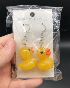 a pair of yellow rubber ducky earrings