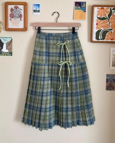 Step back in time with this adorable pleated wrap skirt, inspired by the classic charm of the 1950s. Made from 100% vintage wool, this skirt is both cozy and stylish, perfect for adding a retro flair to your wardrobe. The playful double bow closure adds a cute, eye-catching detail, while the pleated design gives it a flattering shape and flow. Whether you're dressing up for a special occasion or adding a vintage touch to your everyday look, this skirt is a fun and fashionable statement piece you'll love to wear. Key Features: - 100% wool shell - Partial satin lining - Hook closure at waistband - Cotton ties at the front princess seam Size:  - waist 24" - hips 36" - length 27.75" Sew Embroidery, Wool Wrap Skirt, Double Bow, Wool Wrap, Step Back, Princess Seam, The 1950s, Back In Time, Vintage Wool