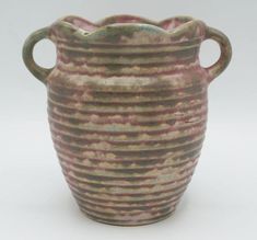 a brown and pink striped vase on a white background