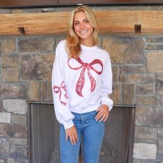 Pink crewneck sweater with a red Christmas bow on the front Disney Pumpkin, Blue Pumpkins, Holiday Wardrobe, Capri Blue, Cute Bow, Simply Southern, Cute Bows, Trending Now, Holiday Cheer