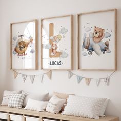 three framed pictures hang on the wall above a bench in a child's room